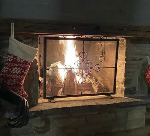 A lit fireplace at Chalet Cervo in Crans-Montana.